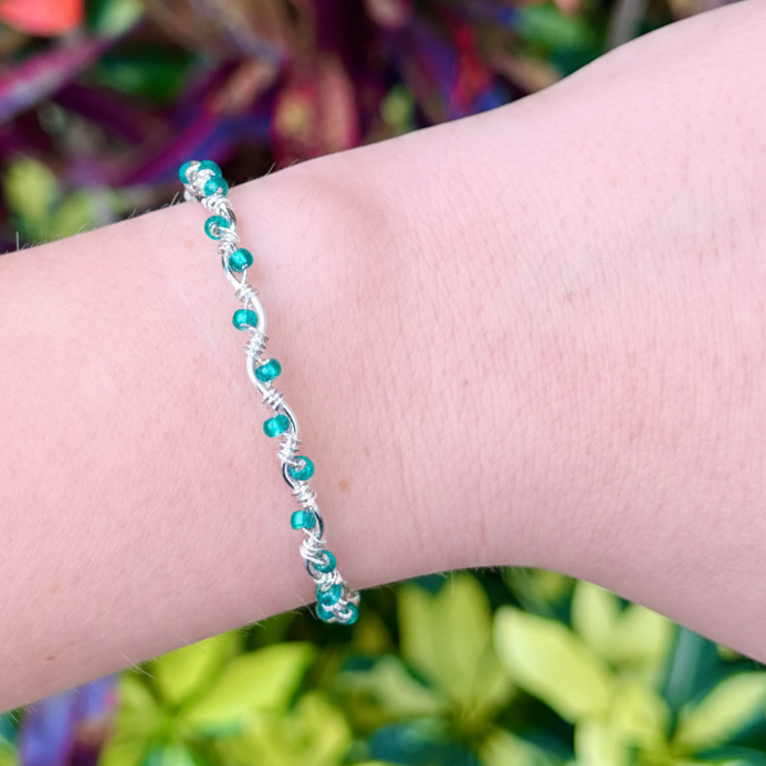 Bracelet on a wrist with a colorful background