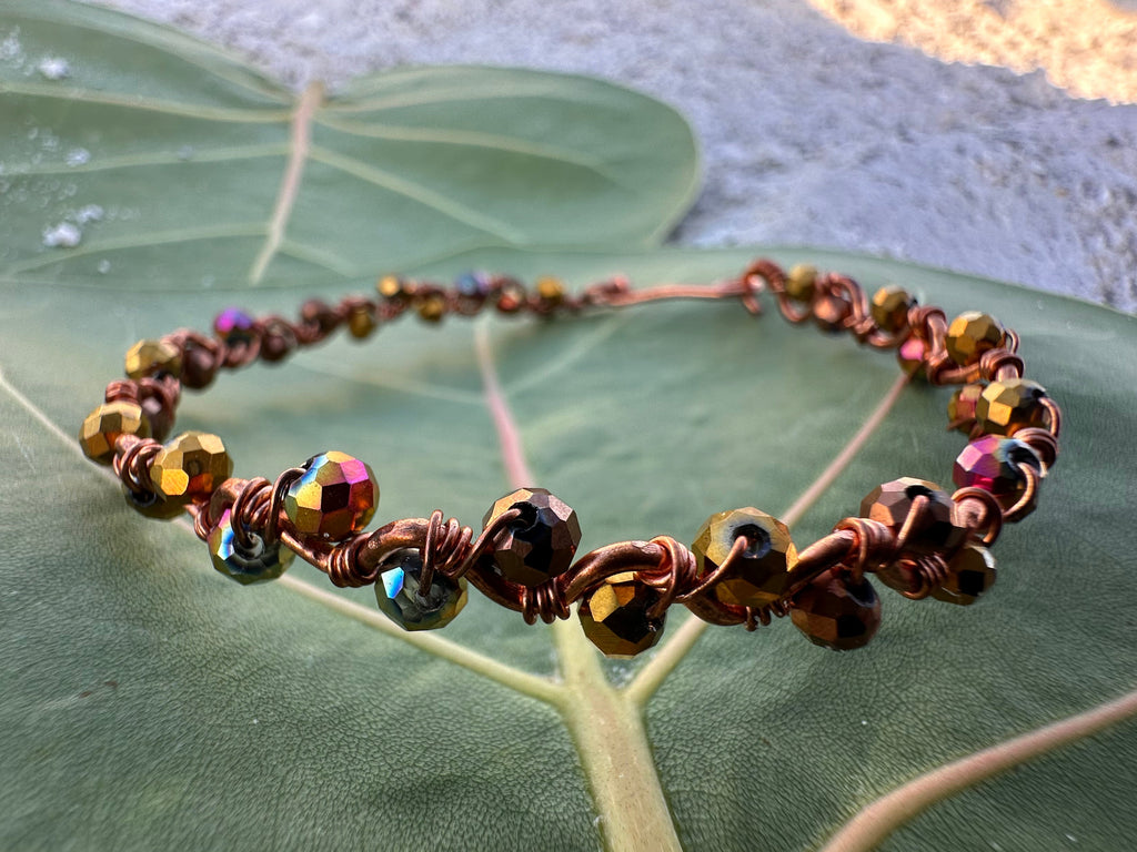 Bracelet with multicolored beads on a large green leaf